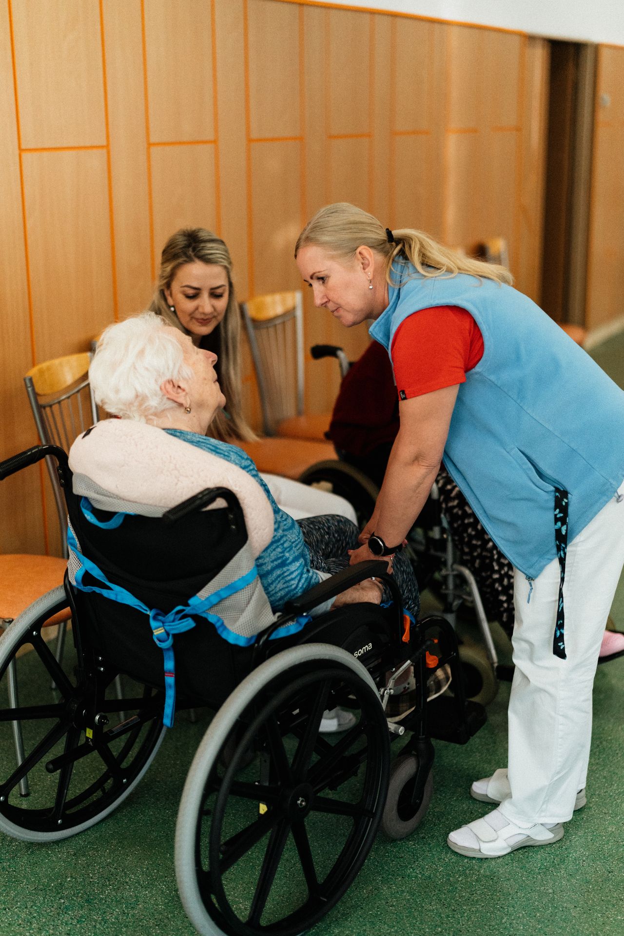 Care workers supporting an elderly patient